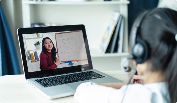 a person wearing headphones and using a laptop