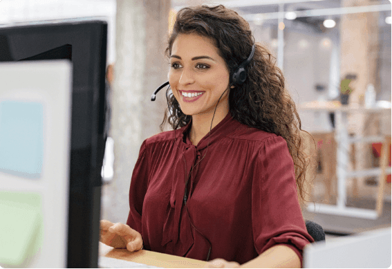 A customer service agent speaking to a customer on their headset.