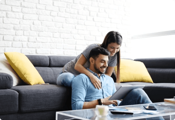 a man and woman looking at a tablet