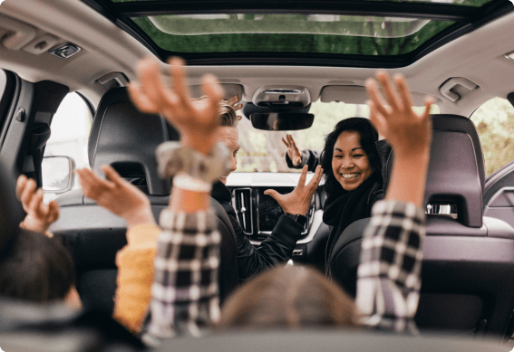 Parents and kids having fun in a car