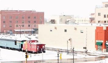 a train on a track in a snowy city