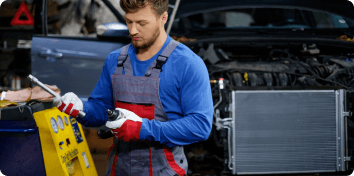 a mechanic holding a car part