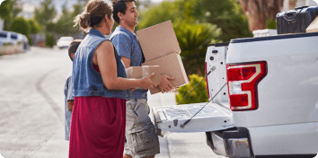 man and woman carrying boxes