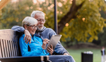 an older couple sitting on a bench