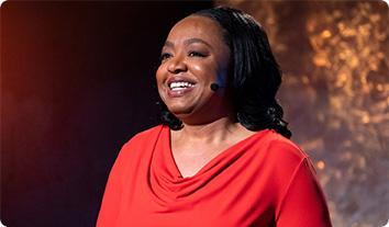 a person smiling with a red shirt