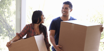 a man and a woman carrying boxes