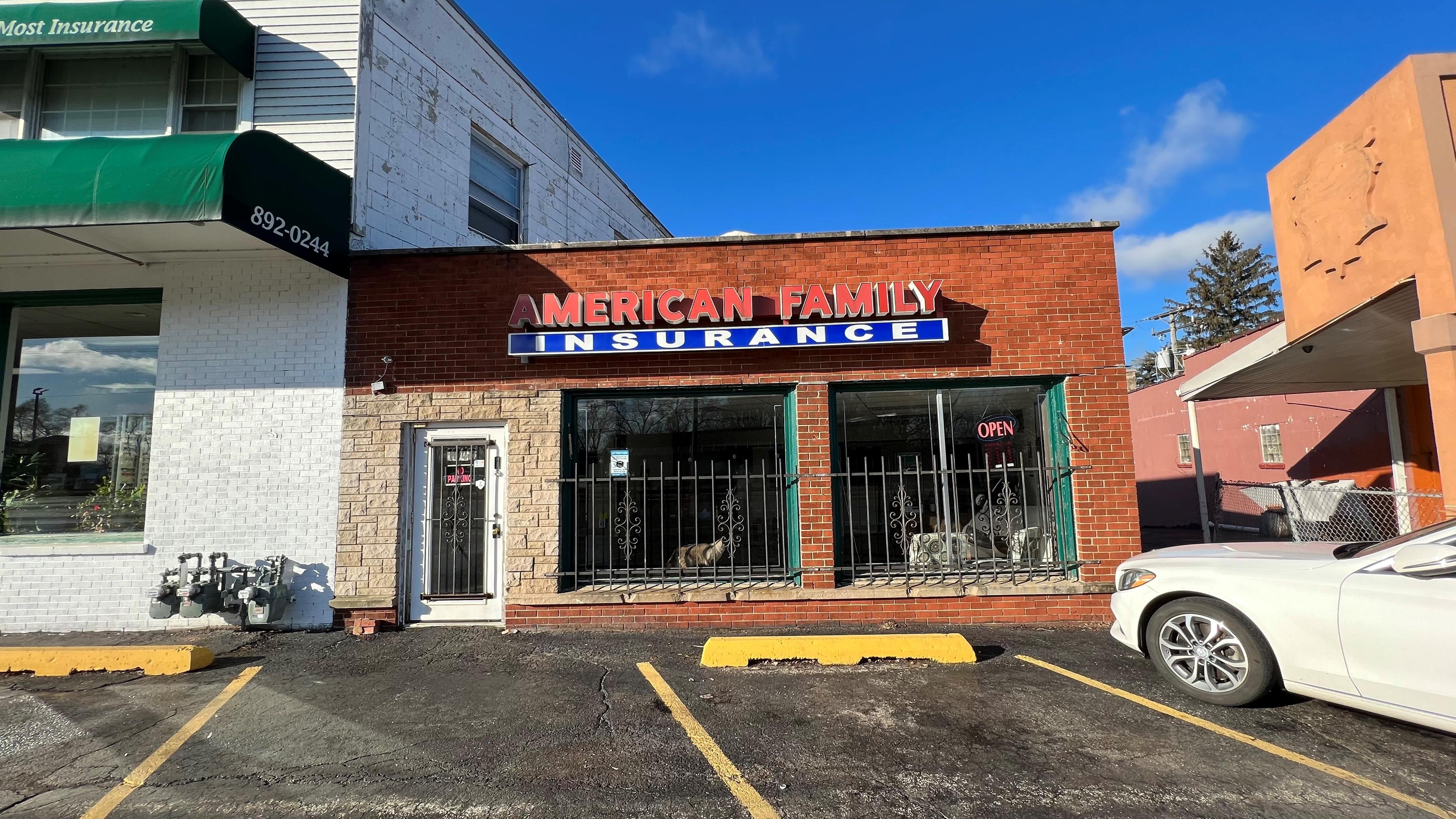 a white car parked outside a store