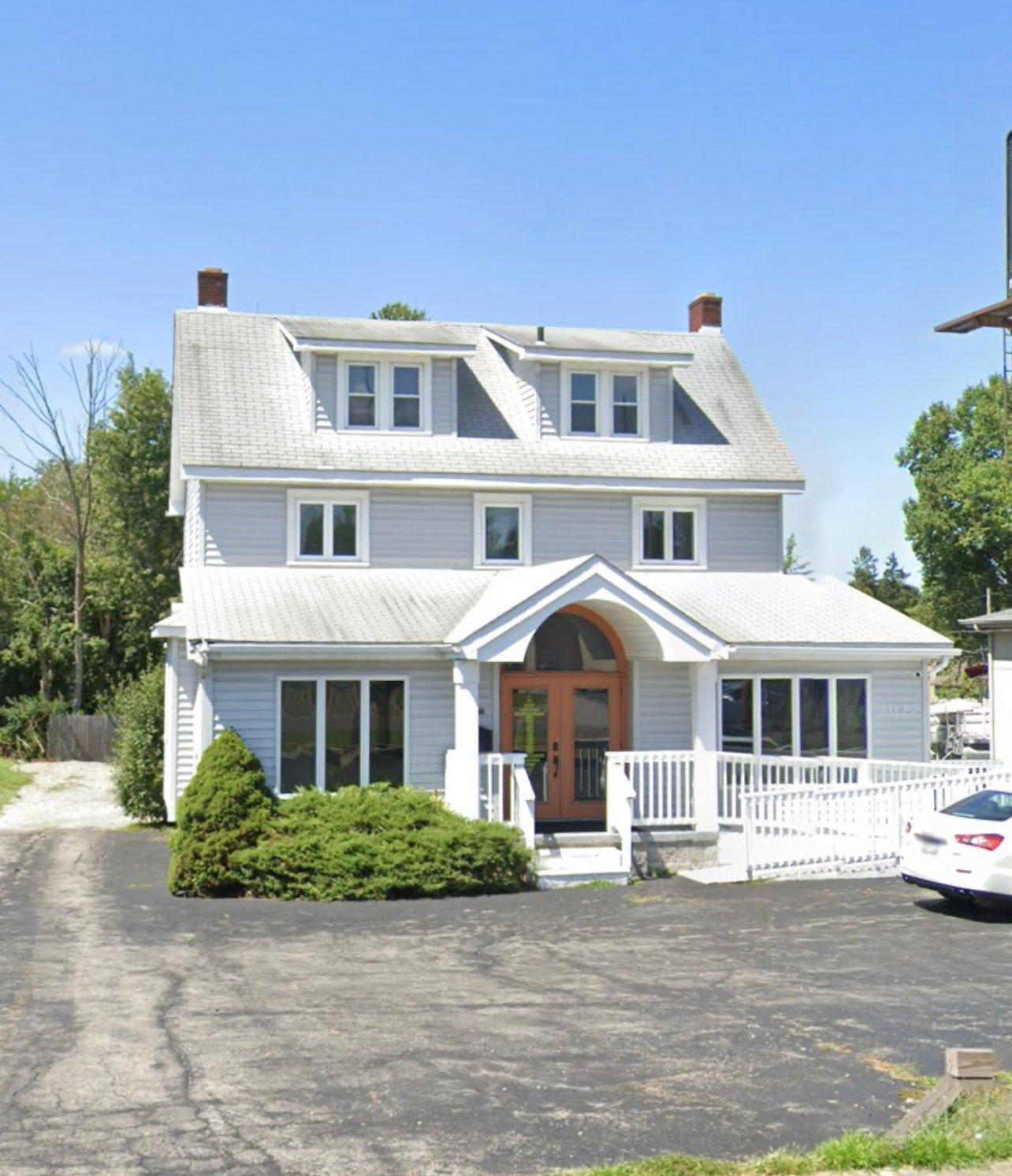 a white house with a driveway