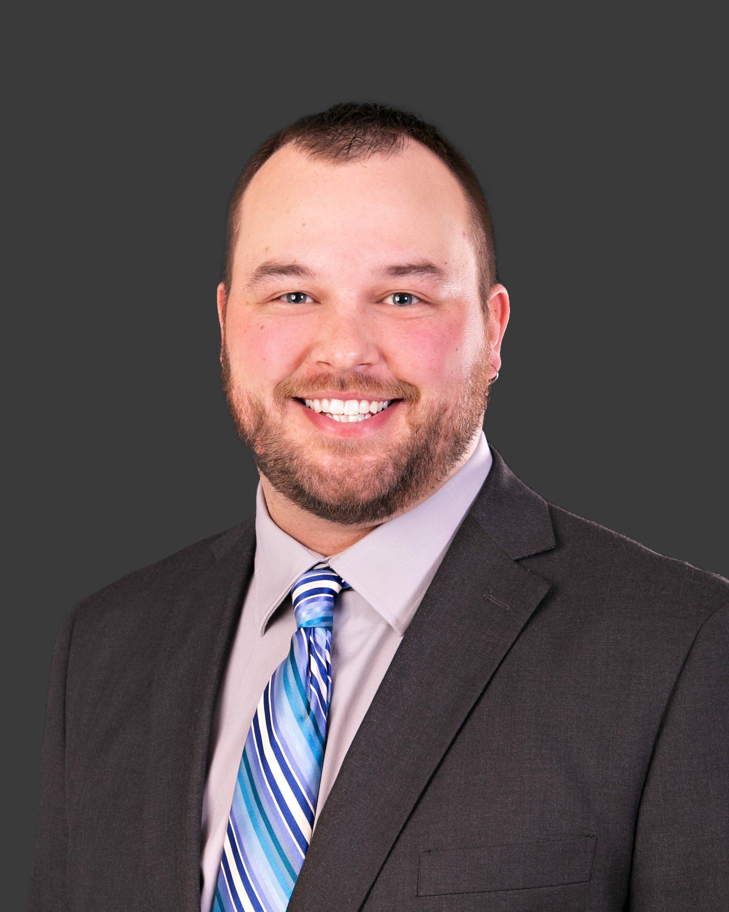 a man in a suit smiling