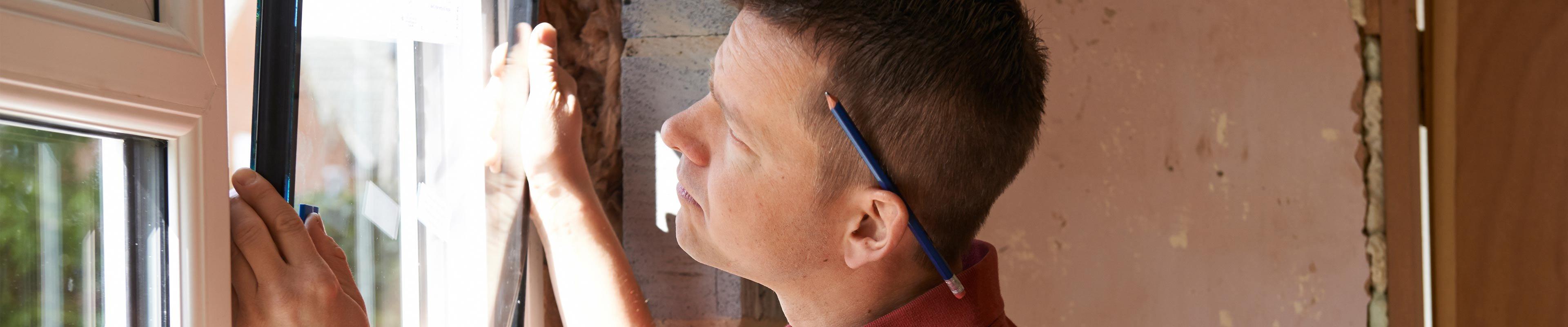 A man installing a new window