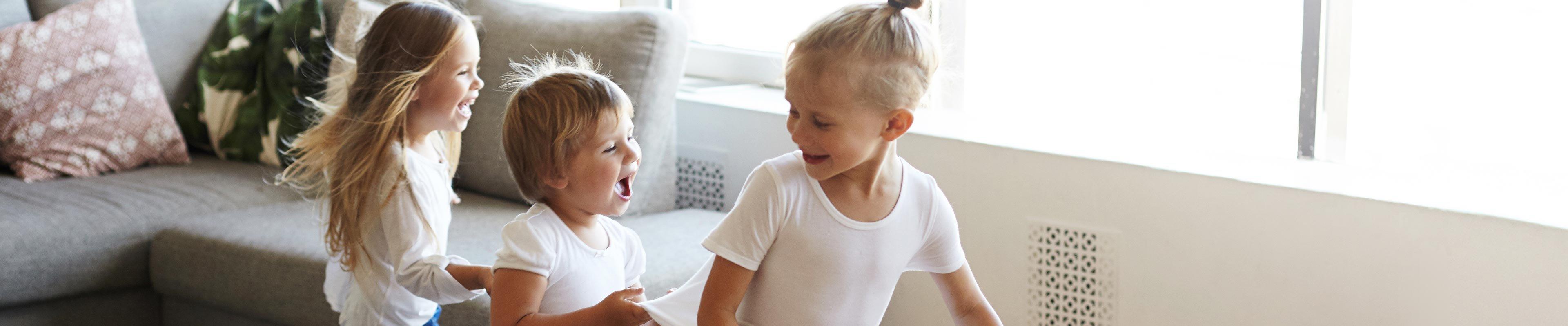 Image of kids dancing in their living room.