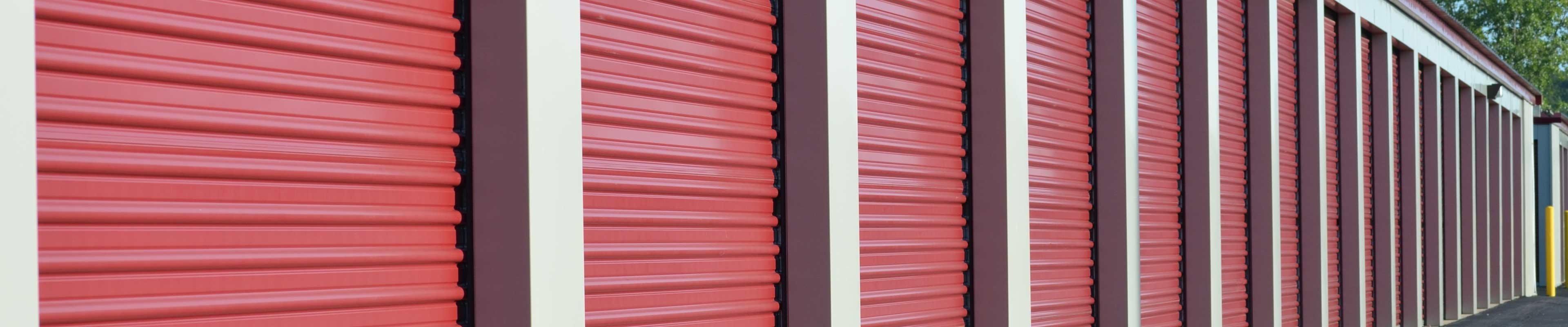 A row of safe storage units with roll-up doors and cylinder locks.