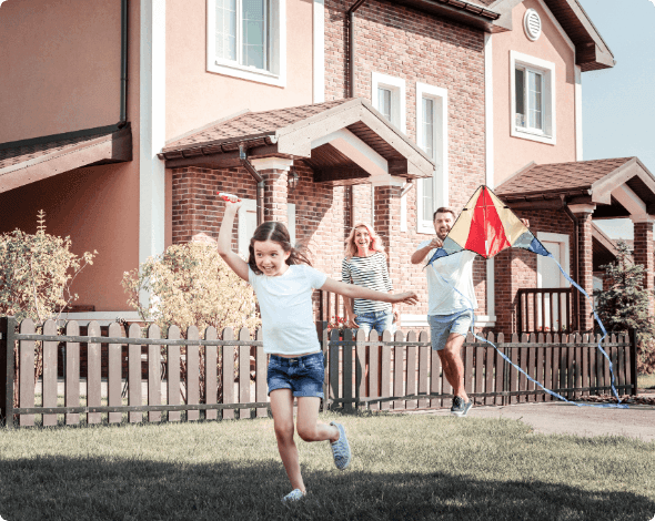 Happy family playing in their yard. 