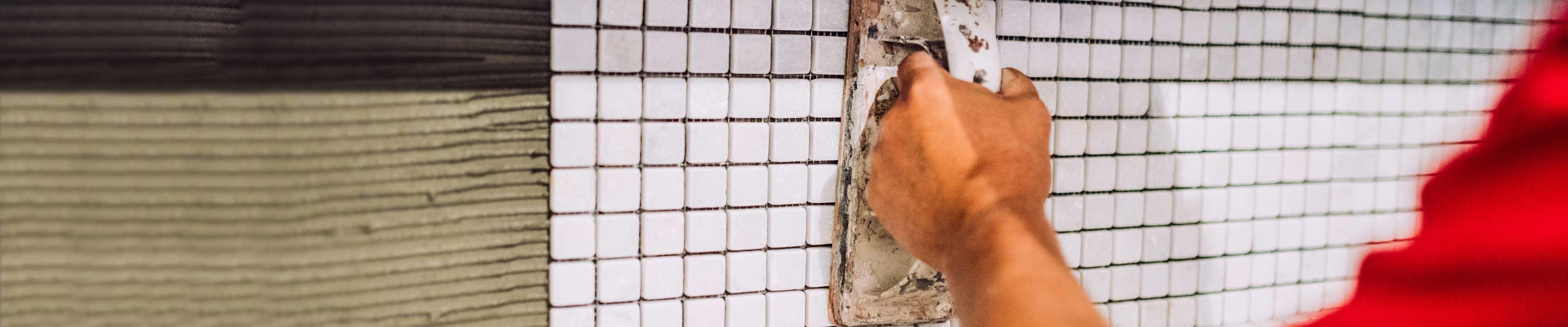 Man grouting a backsplash