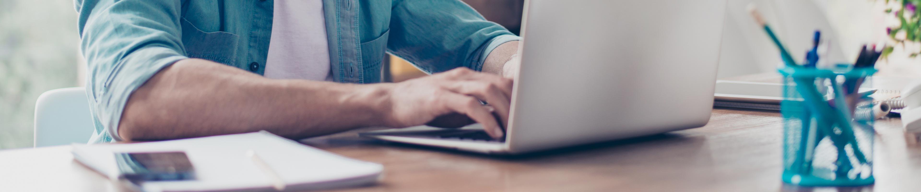 Man using computer to write down goals