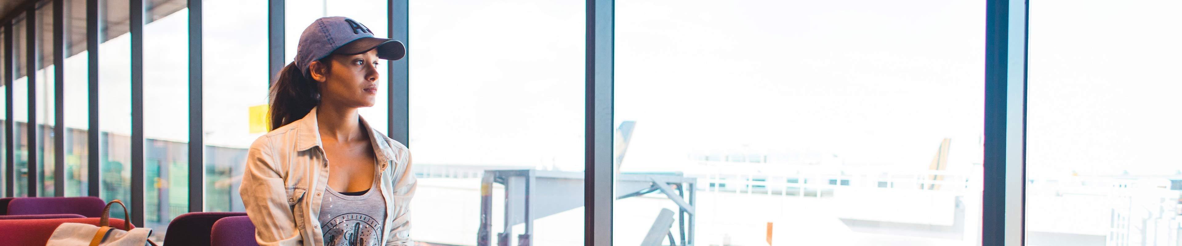 A young woman waits for her flight before her trip abroad.