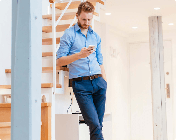 Image of a person looking at homeowners insurance options on a smartphone.