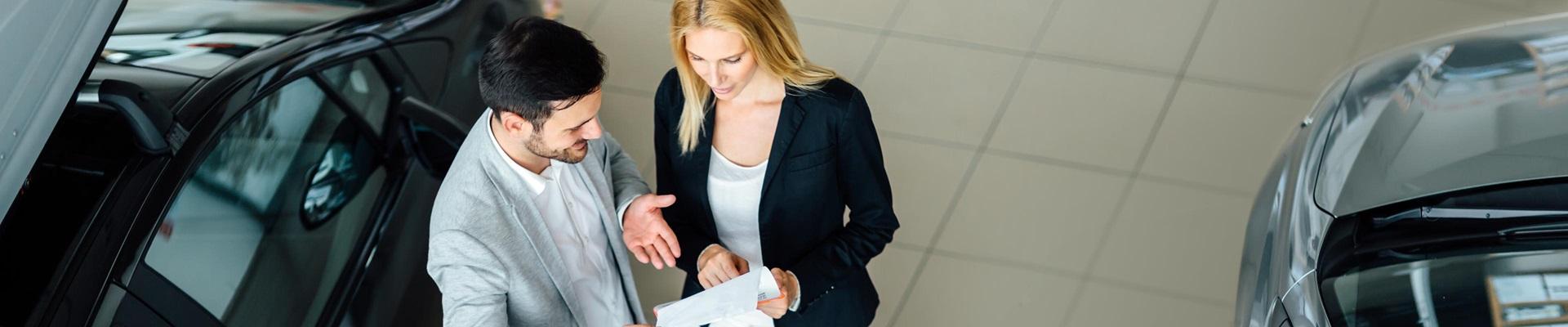 a man and woman looking at a paper