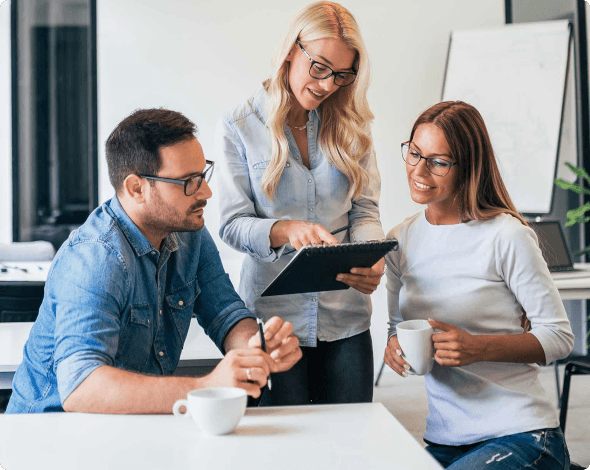 a woman showing an iPad to a couple