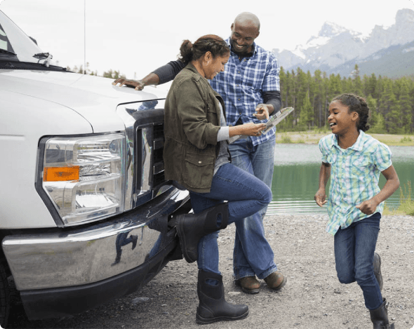 a family of three outside an RV