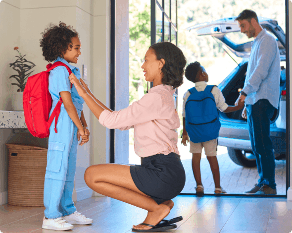 Parents preparing their children for school. 