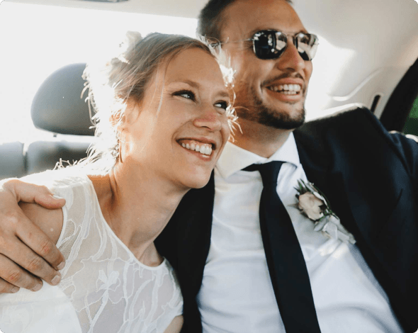 a bride and groom in a car