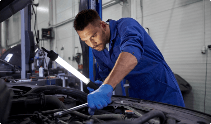 A mechanic working on a car's engine.