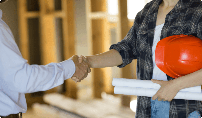 A close-up of a contractor shaking hands with a client.