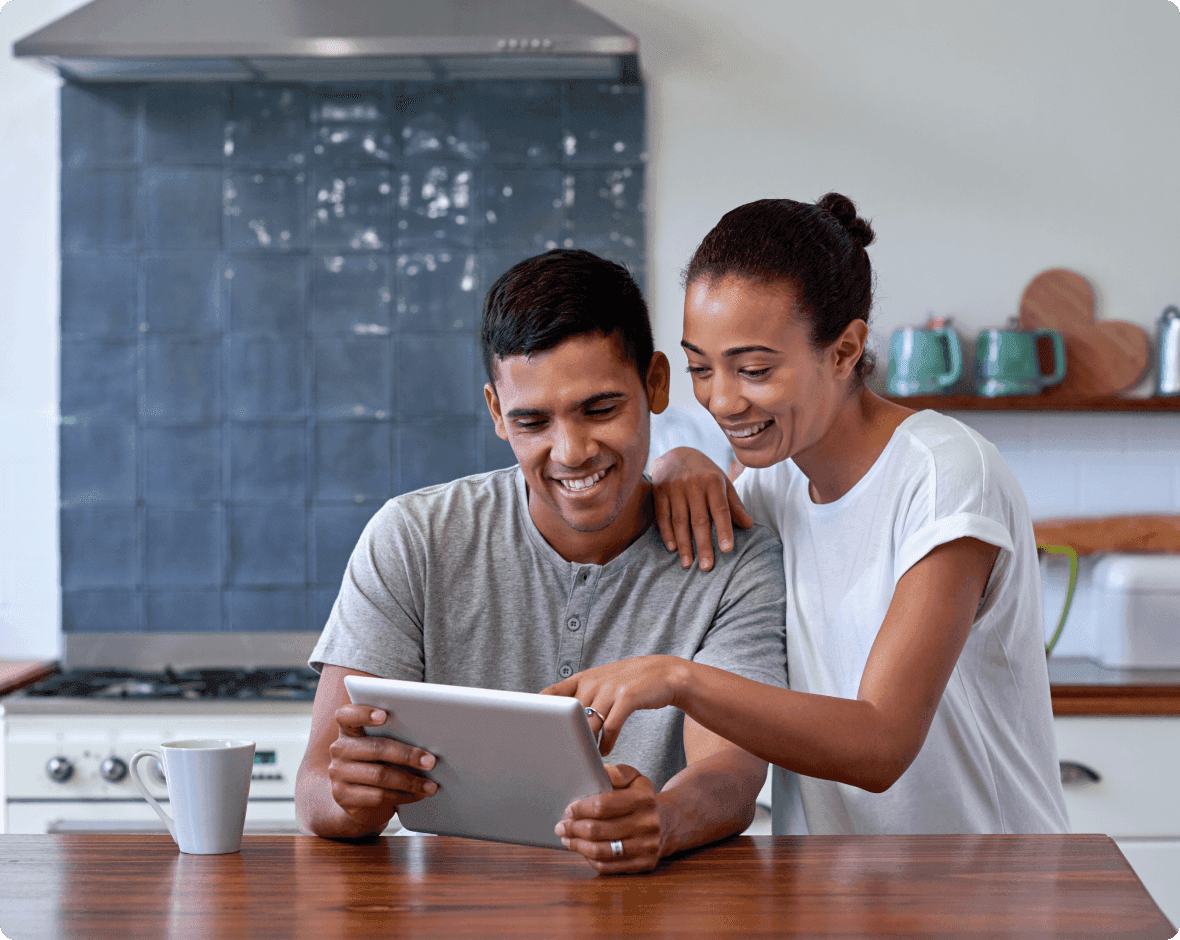 a man and a woman looking at a tablet