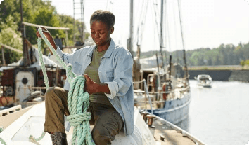 a man holding a net on a boat